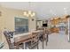 The dining area provides a view of the kitchen, with a full wood table and seating for six at 8230 Agate St, Port Charlotte, FL 33981