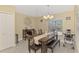Open dining area features wood table, bench seating, large wall clock and lots of natural light at 8230 Agate St, Port Charlotte, FL 33981