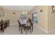 Sunny dining room with tile floors, traditional furnishings and natural light from the windows at 8230 Agate St, Port Charlotte, FL 33981