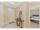 Bright entryway features neutral tile, an ornate mirror, and a glimpse into the bedroom at 8230 Agate St, Port Charlotte, FL 33981