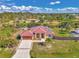 Charming home with a well-manicured lawn, red metal roof, and a freshly sealed driveway at 8230 Agate St, Port Charlotte, FL 33981