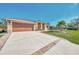 Spacious home with brick-lined driveway and an attached garage provides ample parking at 8230 Agate St, Port Charlotte, FL 33981