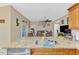 Open kitchen view showcasing the granite countertops, stainless steel appliances, and adjacent living room at 8230 Agate St, Port Charlotte, FL 33981