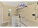 Convenient laundry room with washer, dryer, sink, and ample storage space at 8230 Agate St, Port Charlotte, FL 33981