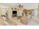 Cozy living area featuring tile flooring, a ceiling fan, and seamlessly connected to the kitchen at 8230 Agate St, Port Charlotte, FL 33981