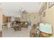 Open-concept living room with neutral tones, ceiling fan, and access to a large backyard through sliding glass doors at 8230 Agate St, Port Charlotte, FL 33981