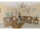 Inviting living room featuring neutral walls, tile floors, cozy seating and a ceiling fan at 8230 Agate St, Port Charlotte, FL 33981