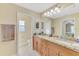 This bathroom features a double sink vanity and a large, well-lit mirror at 8230 Agate St, Port Charlotte, FL 33981