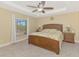 Main bedroom features a trey ceiling, a large bed, and an abundance of natural light at 8230 Agate St, Port Charlotte, FL 33981