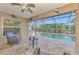 Enclosed patio area overlooking a pool with outdoor seating and ceiling fan at 8230 Agate St, Port Charlotte, FL 33981