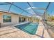 Beautiful screened-in pool area with lush landscaping offering privacy at 8230 Agate St, Port Charlotte, FL 33981