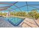 Private, screened pool area with a peaceful setting and lush landscaping at 8230 Agate St, Port Charlotte, FL 33981