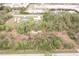 An aerial view of a property featuring verdant trees and vegetation at 11369 1St Ave, Punta Gorda, FL 33955