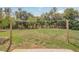 Expansive backyard featuring lush greenery and a clothesline, perfect for outdoor activities at 11369 1St Ave, Punta Gorda, FL 33955