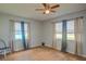 Bright bedroom with wood floors, neutral walls, and two windows dressed with stylish curtains at 11369 1St Ave, Punta Gorda, FL 33955