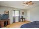 Comfortable bedroom featuring wood flooring, a ceiling fan, and a window for natural light at 11369 1St Ave, Punta Gorda, FL 33955