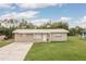 Charming single-story home with a well-manicured lawn and neutral stucco exterior, complemented by a light-colored roof at 11369 1St Ave, Punta Gorda, FL 33955