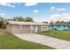 Charming single-story home with a well-manicured lawn and a long driveway, showcasing curb appeal at 11369 1St Ave, Punta Gorda, FL 33955