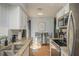 Modern kitchen featuring white cabinetry, granite counters, and stainless steel appliances near a cozy dining area at 11369 1St Ave, Punta Gorda, FL 33955