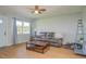 Cozy living room with wood-look flooring, a comfortable sofa, and a bright window with natural light at 11369 1St Ave, Punta Gorda, FL 33955