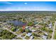 Aerial view of neighborhood highlighting a specific house near the lake at 1391 Abalom St, Punta Gorda, FL 33980