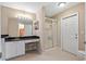 Bright bathroom featuring a vanity with granite countertop and a glass-enclosed shower at 1391 Abalom St, Punta Gorda, FL 33980