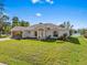 Charming single-story home featuring a well-maintained lawn, colorful landscaping, and an attached two-car garage at 1391 Abalom St, Punta Gorda, FL 33980
