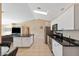 Bright kitchen with stainless appliances, granite countertops, and a breakfast bar overlooking the living area at 1391 Abalom St, Punta Gorda, FL 33980