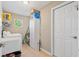 Laundry room with sink, cabinet and access to the exterior at 1391 Abalom St, Punta Gorda, FL 33980