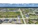 Wide aerial shot of a residential area with homes, roadways, a pond, and natural Florida landscape at 149 Hercules Dr, Rotonda West, FL 33947