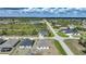 Wide aerial shot of a residential area with homes, roadways, a pond, and natural Florida landscape at 149 Hercules Dr, Rotonda West, FL 33947