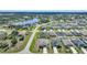 Overview of a residential community with homes, streets, and a scenic pond surrounded by lush trees at 149 Hercules Dr, Rotonda West, FL 33947