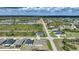 Areal shot of a residential area with homes, roadways, a pond, and natural Florida landscape at 149 Hercules Dr, Rotonda West, FL 33947