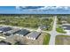 Wide aerial shot of a residential area with homes, roadways, a pond, and natural Florida landscape at 149 Hercules Dr, Rotonda West, FL 33947