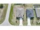 Aerial view of two well-maintained homes showing the roofs, driveways, and tidy landscaping at 149 Hercules Dr, Rotonda West, FL 33947