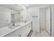 Bright bathroom with a double sink vanity, neutral tile flooring, and large mirror at 149 Hercules Dr, Rotonda West, FL 33947