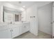 Bathroom featuring double sink vanity with white cabinets and light tile flooring at 149 Hercules Dr, Rotonda West, FL 33947