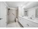 Modern bathroom featuring dual sinks, a walk-in shower, and neutral tile at 149 Hercules Dr, Rotonda West, FL 33947