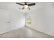 Bedroom featuring a ceiling fan, tile flooring, and a large window at 149 Hercules Dr, Rotonda West, FL 33947