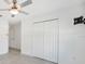 Cozy bedroom featuring a ceiling fan, closet with white doors, and tile flooring at 149 Hercules Dr, Rotonda West, FL 33947