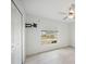 Bright bedroom featuring a ceiling fan, tile floors, and large window at 149 Hercules Dr, Rotonda West, FL 33947