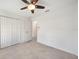 Bright bedroom featuring tile floors, a ceiling fan, and white doors at 149 Hercules Dr, Rotonda West, FL 33947