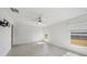 Bright bedroom featuring tile flooring, a ceiling fan, and large windows at 149 Hercules Dr, Rotonda West, FL 33947