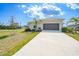 Charming single-story home with a well-manicured lawn and a two-car garage in a quiet neighborhood at 149 Hercules Dr, Rotonda West, FL 33947