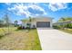 Charming single-story home with a well-manicured front lawn, landscaping, and inviting curb appeal at 149 Hercules Dr, Rotonda West, FL 33947