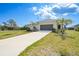 Beautiful single-Gathering home featuring an attached garage, manicured lawn, and fresh landscaping at 149 Hercules Dr, Rotonda West, FL 33947