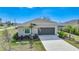Beautiful single-Gathering home featuring an attached garage, manicured lawn, and fresh landscaping at 149 Hercules Dr, Rotonda West, FL 33947