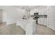 Bright kitchen featuring a large island, white cabinets, and stainless steel appliances at 149 Hercules Dr, Rotonda West, FL 33947
