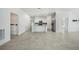 Open-concept living room and kitchen with light-colored tile and stainless steel appliances at 149 Hercules Dr, Rotonda West, FL 33947