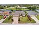 Stunning aerial view of a beautiful home with a well-manicured lawn, brick driveway and a nearby canal at 158 Mariner Ln, Rotonda West, FL 33947